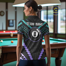 Load image into Gallery viewer, Woman wearing a teal and purple 8 ball tribal billiard jersey beside a pool table front view.