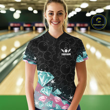 Load image into Gallery viewer, Woman wearing a black bowling shirt with diamonds patterns in a bowling alley.