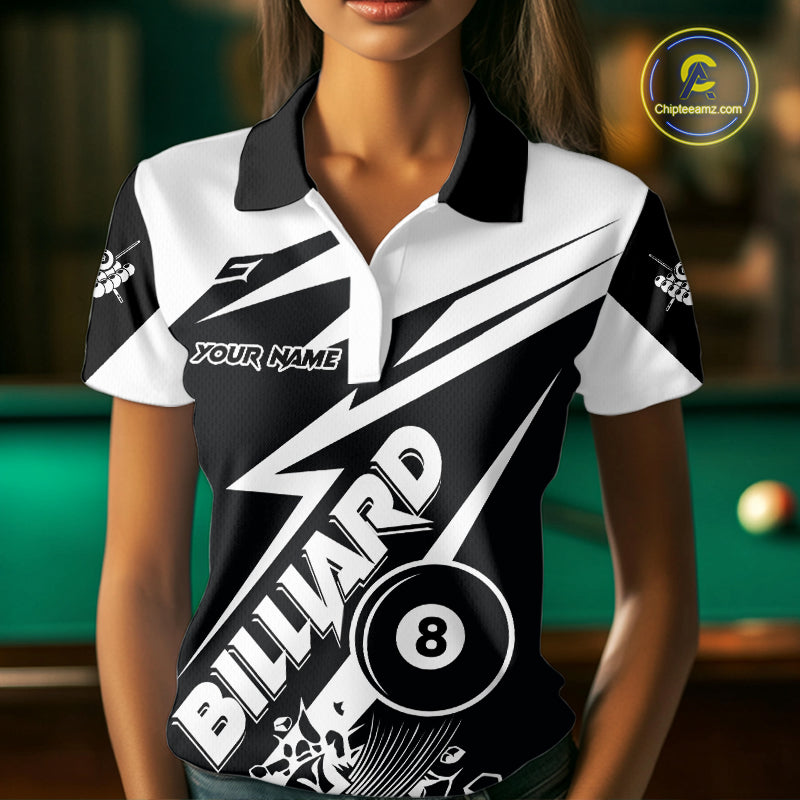 Woman wearing a funny black and white 8 ball billiard jersey beside a pool table front view.