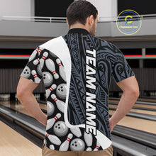 Load image into Gallery viewer, Back view of man wearing a blue tribal pattern bowling quarter zip shirt in a bowling alley.