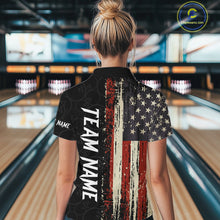 Load image into Gallery viewer, Back view of woman wearing a vintage American flag bowling polo shirt inside a bowling alley.