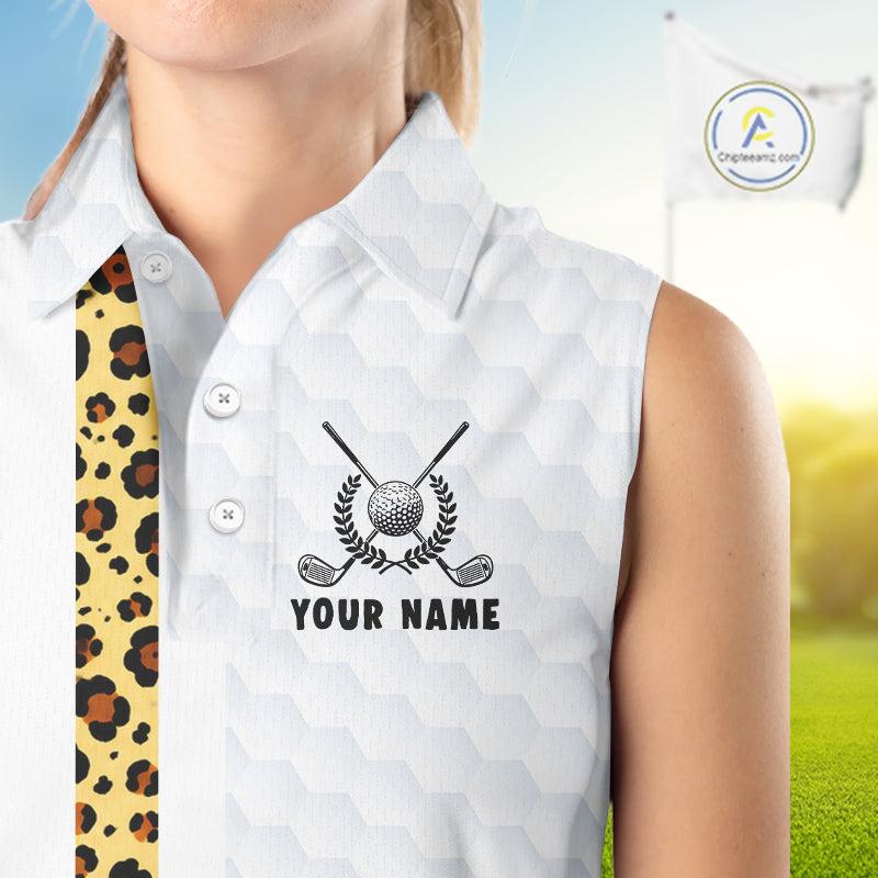White sleeveless golf shirt with golf club and ball design, personalized with 'Your Name', on a blurred golf course background.