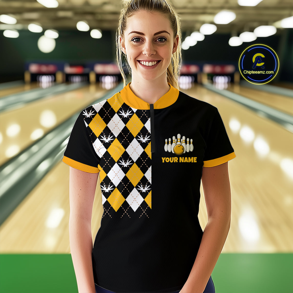 Woman wearing a black and yellow bowling shirt with a logo in a bowling alley.