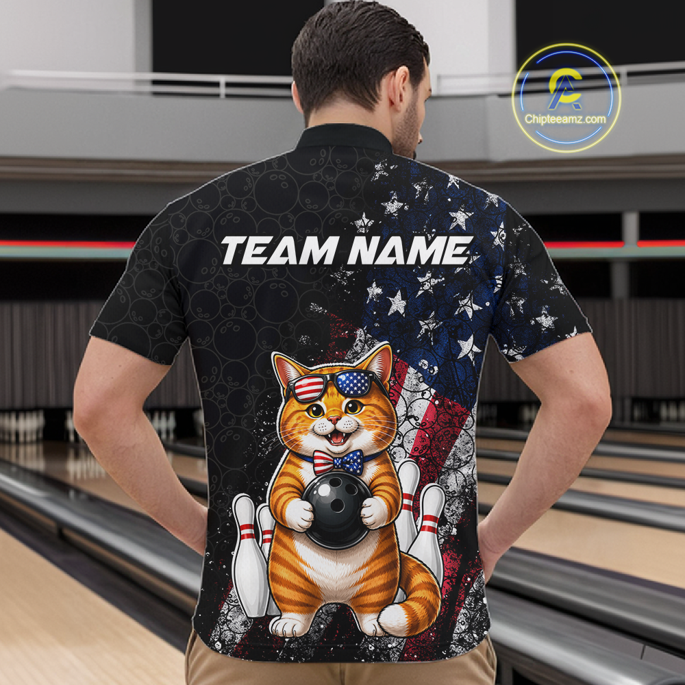 Man wearing a bowling-themed shirt with a cat holding a bowling ball and American flag design, standing in a bowling alley.